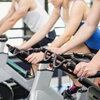 Fit group of people using exercise bike together