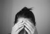 Woman in Distress Touching Forehead
