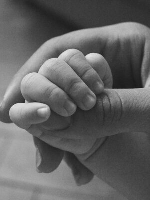 Parent Holding a Baby's Hand