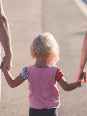 Parents With Child Holding Hands