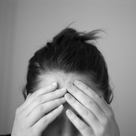 Woman in Distress Touching Forehead