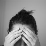 Woman in Distress Touching Forehead